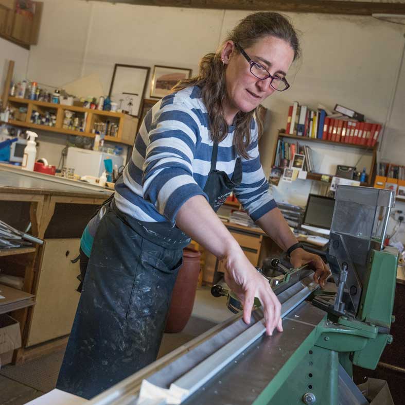 Heather Green GCF (APF), framing expert in the workshop at Walsingham Gallery and Framing