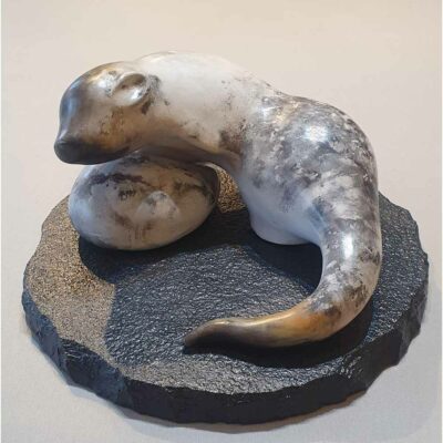 Smoke fired stoneware sculpture 'Large Otter' on a slate base, by Carol Pask