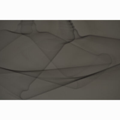 Photograph entitled 'the coathangers in mimi's hall' by Han Lee de Boer